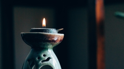 Lit tealight positioned on a holder